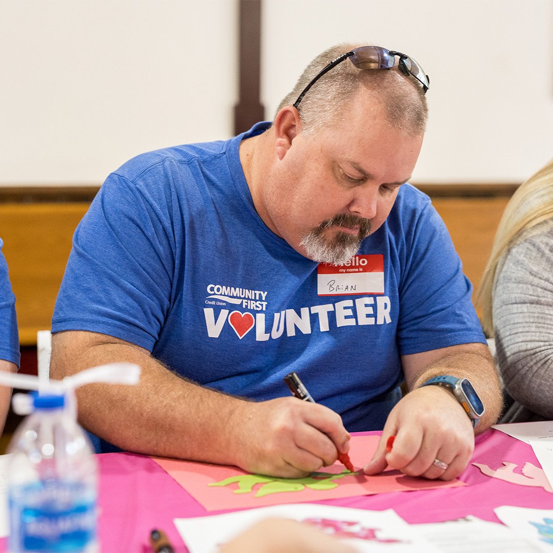 Volunteer coloring an ornament. Volunteer coloring an ornament.