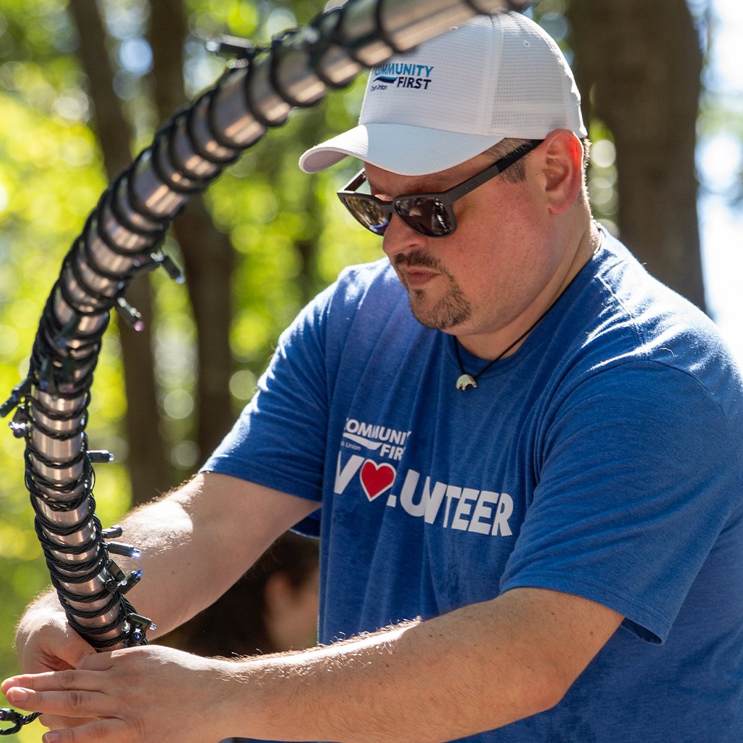 Volunteer wrapping Christmas lights.