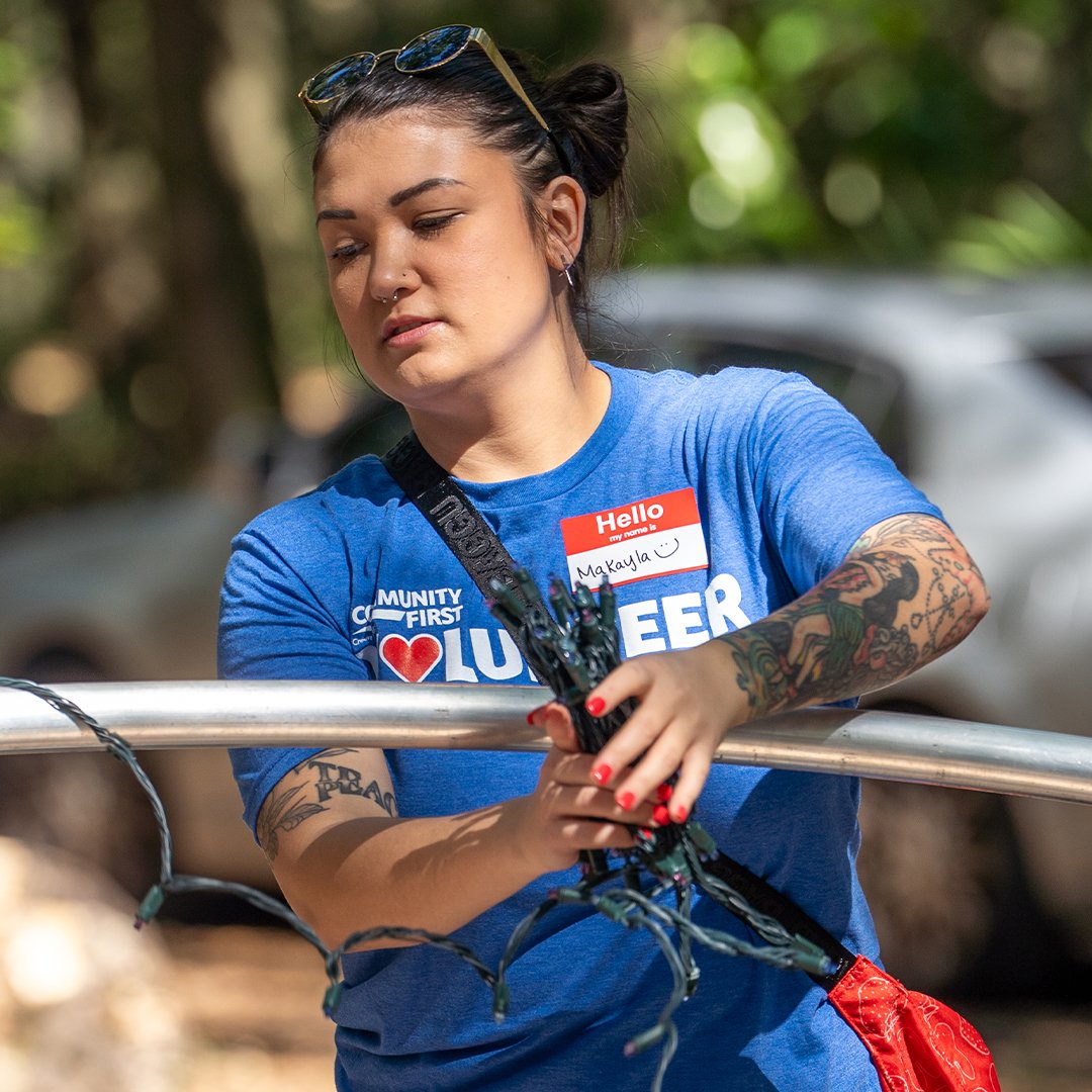 Volunteer wrapping Christmas lights.