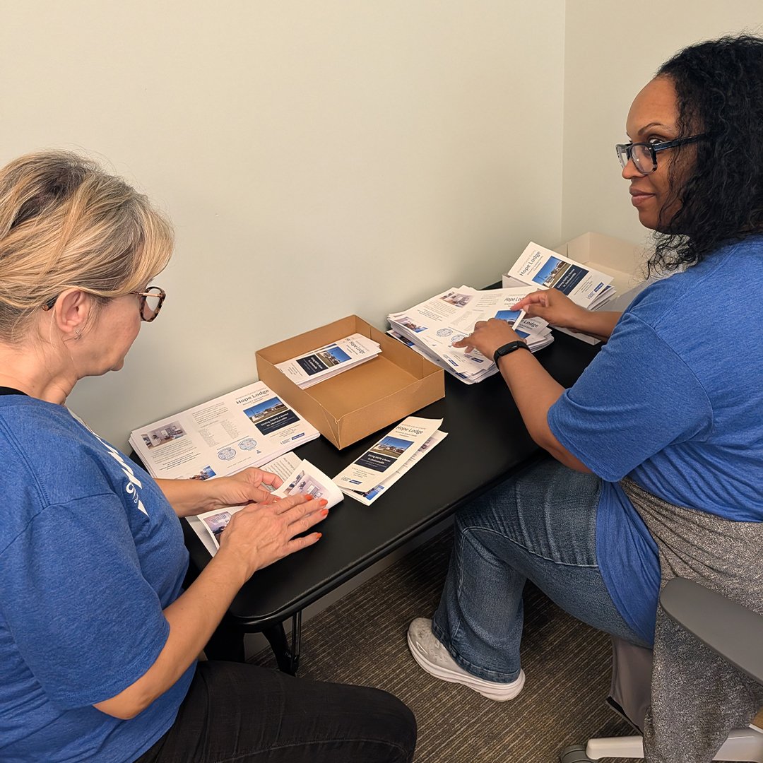 Volunteers sorting through brochures.