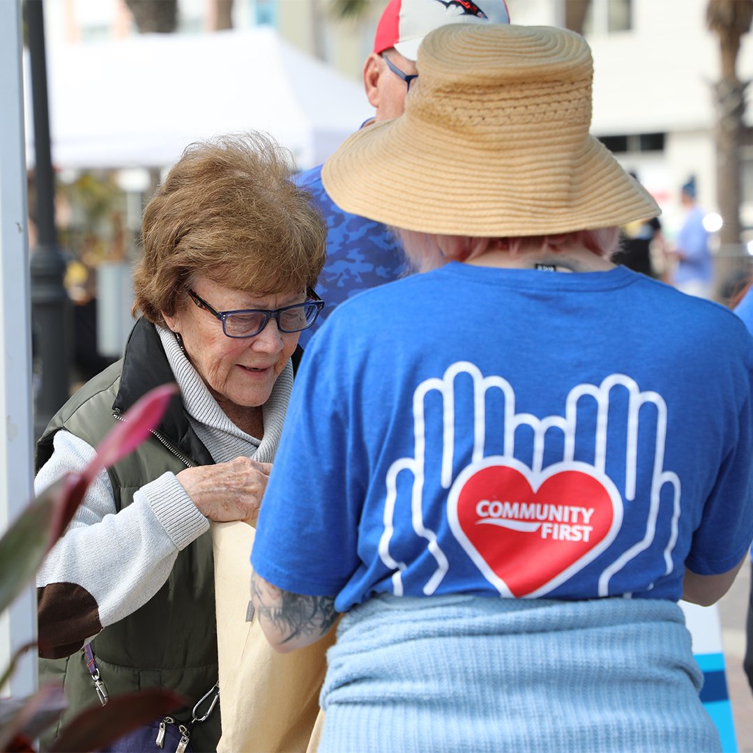 Volunteer speaking to member.