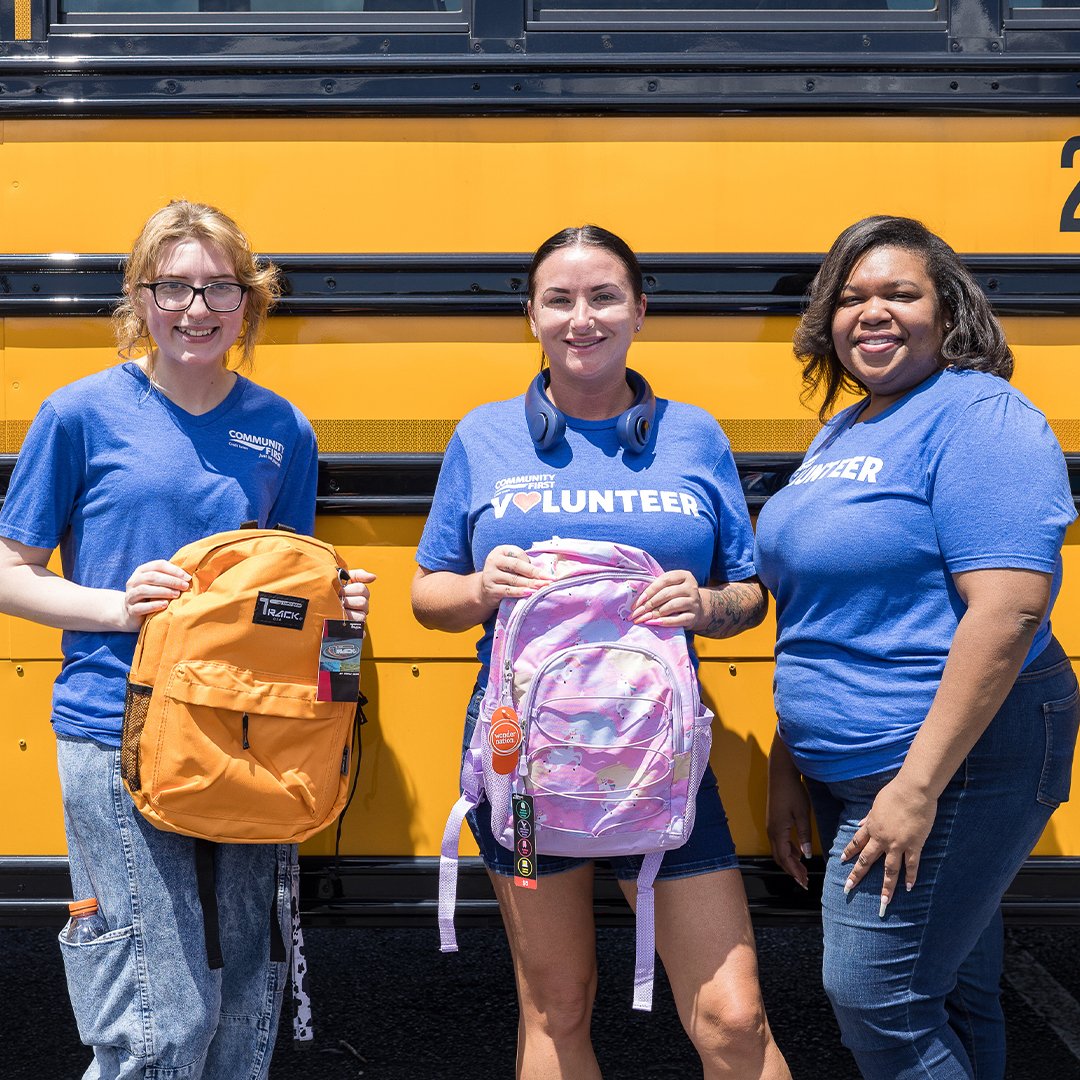 Volunteers with school supplies.