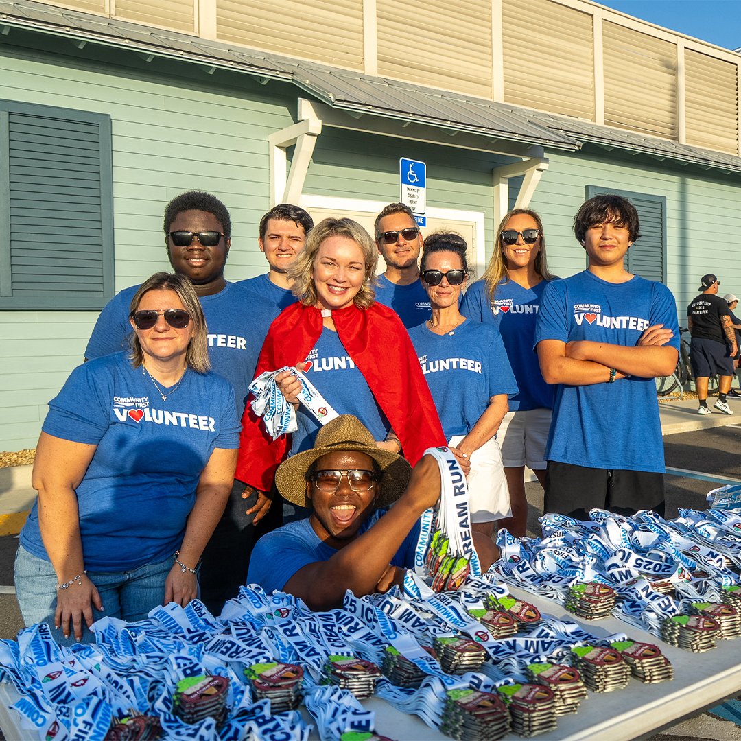 Volunteers posing with medals at Kilwins Ice Cream Run.