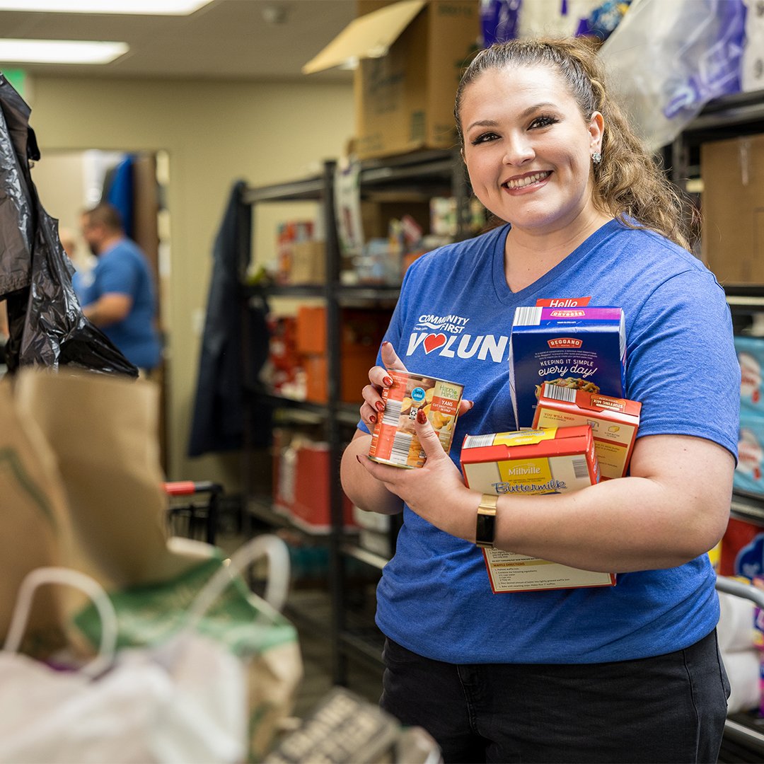 Volunteer smiling while sorting food.