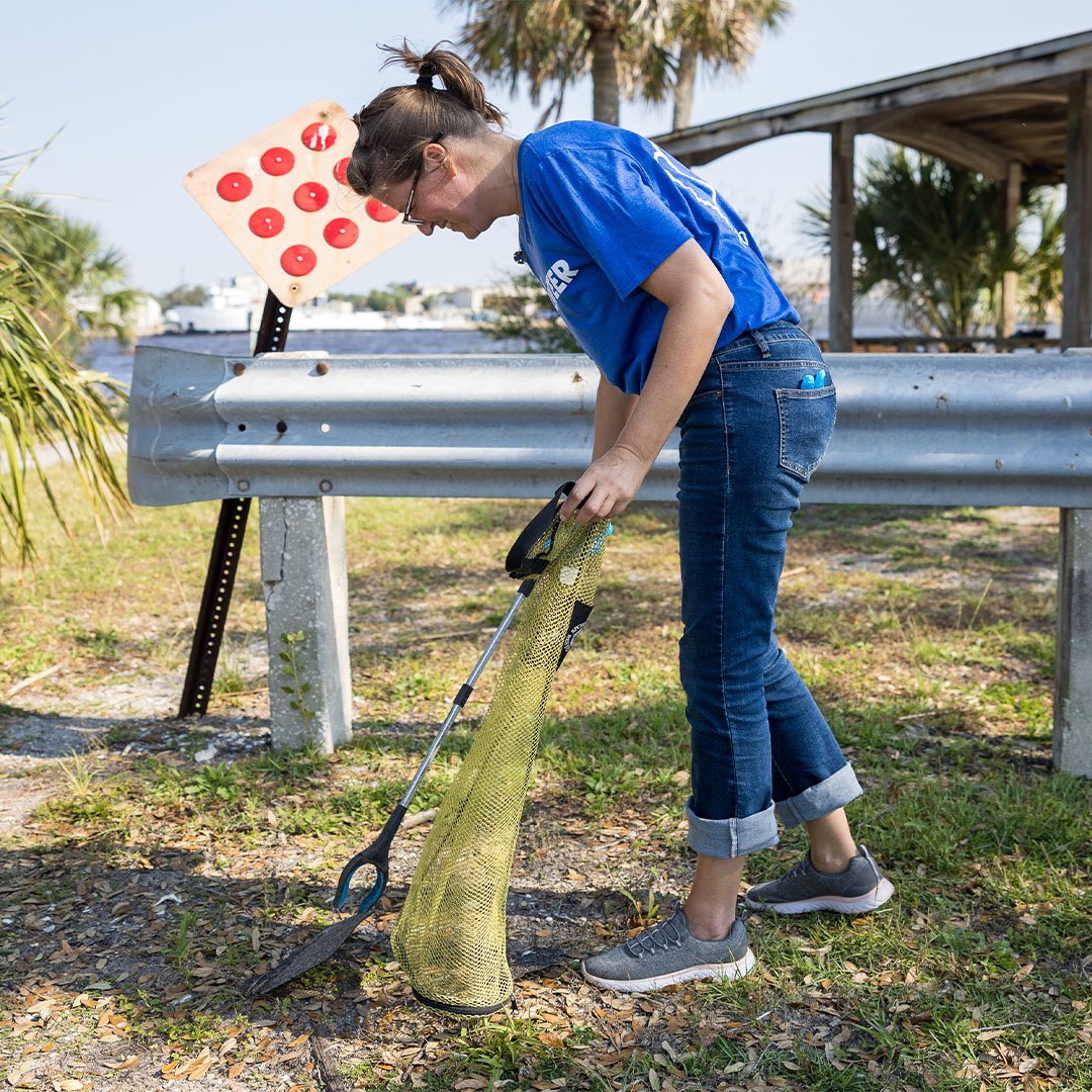 Volunteer picking up trash.