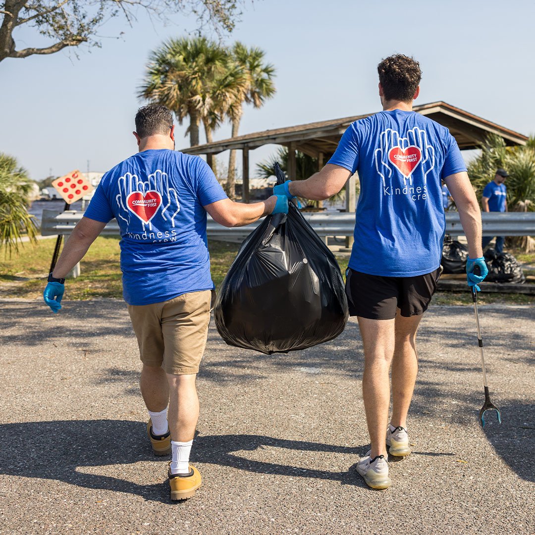 Volunteers carrying trash bag