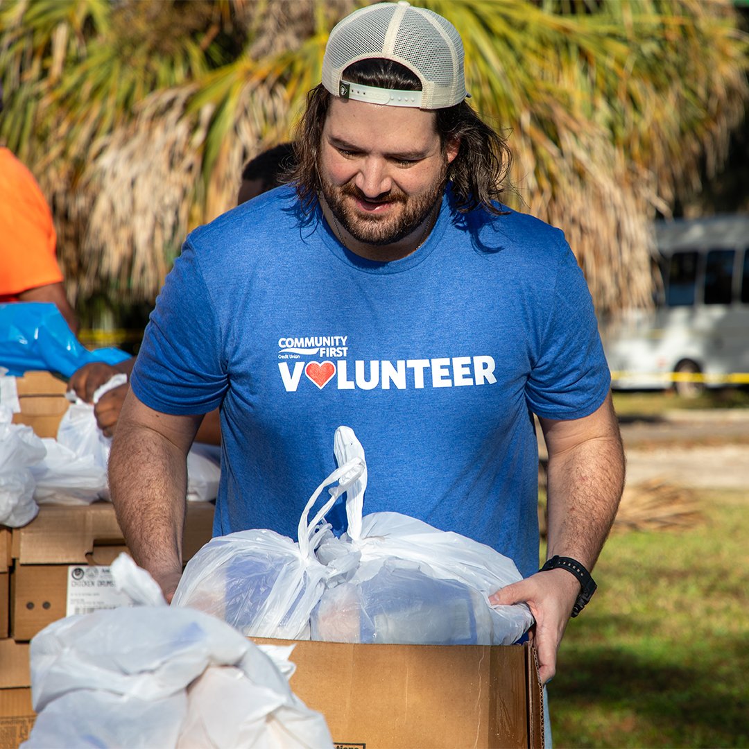 Volunteer walking with food at EWU food drive.