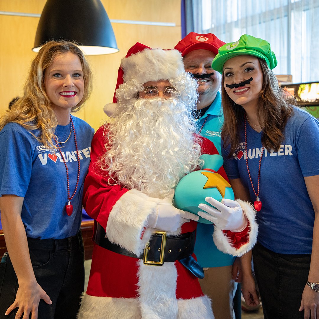 Volunteers posing with Santa at GAAM Holiday Nerd Market.