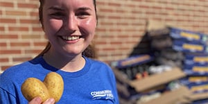Woman holding heart shaped potato. Woman holding heart shaped potato.