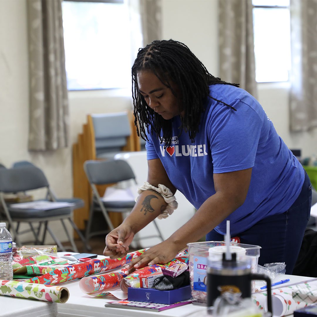 Volunteer wrapping presents.