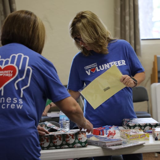 Volunteer sorting gifts.