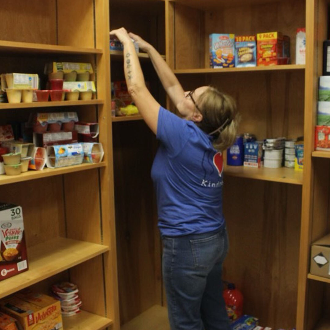 Volunteer stocking pantry.