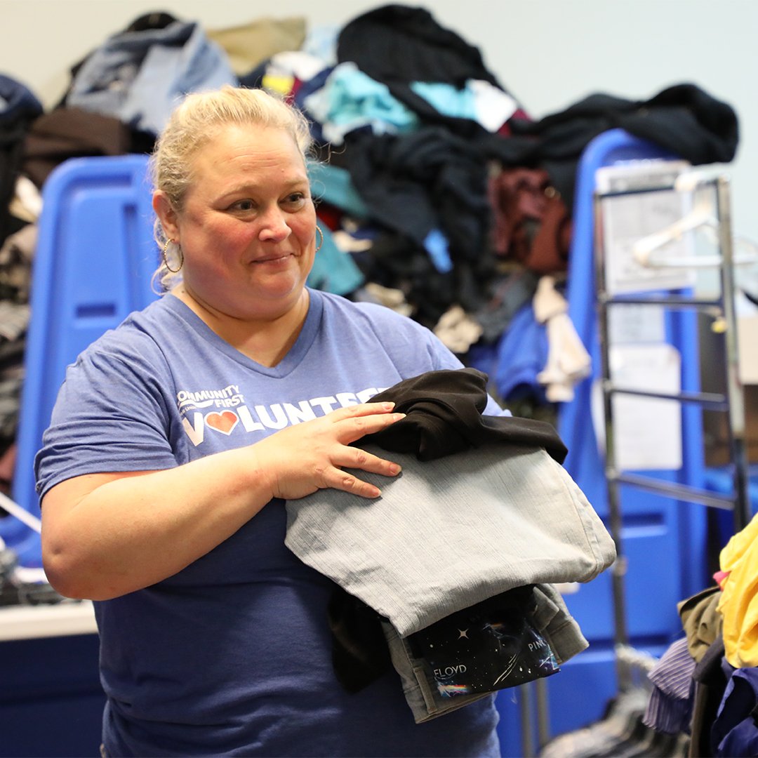 Volunteer sorting through clothing. Volunteer sorting through clothing.
