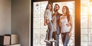 Young family walking into home