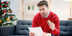 Man looking over credit card statement.